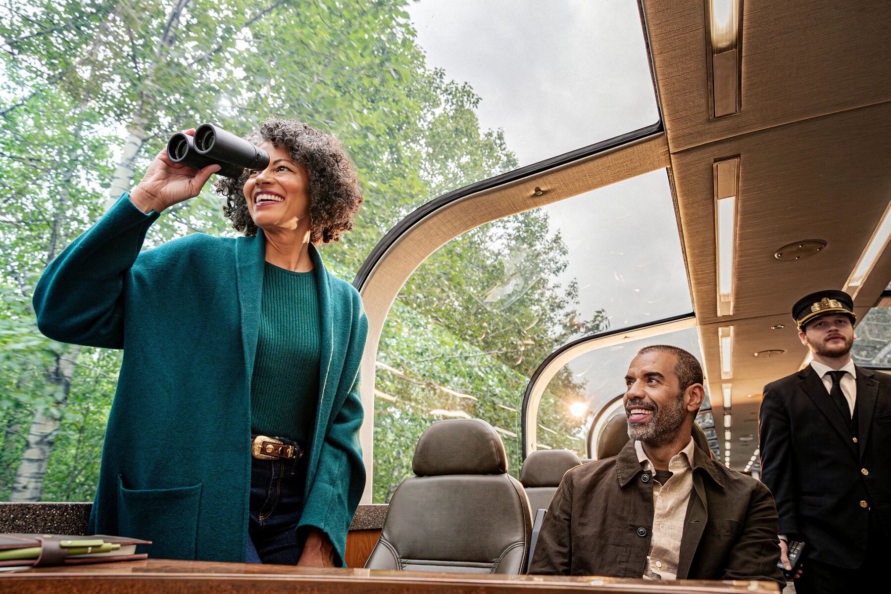 Travelers enjoying the view from inside a glass-domed Princess railcar