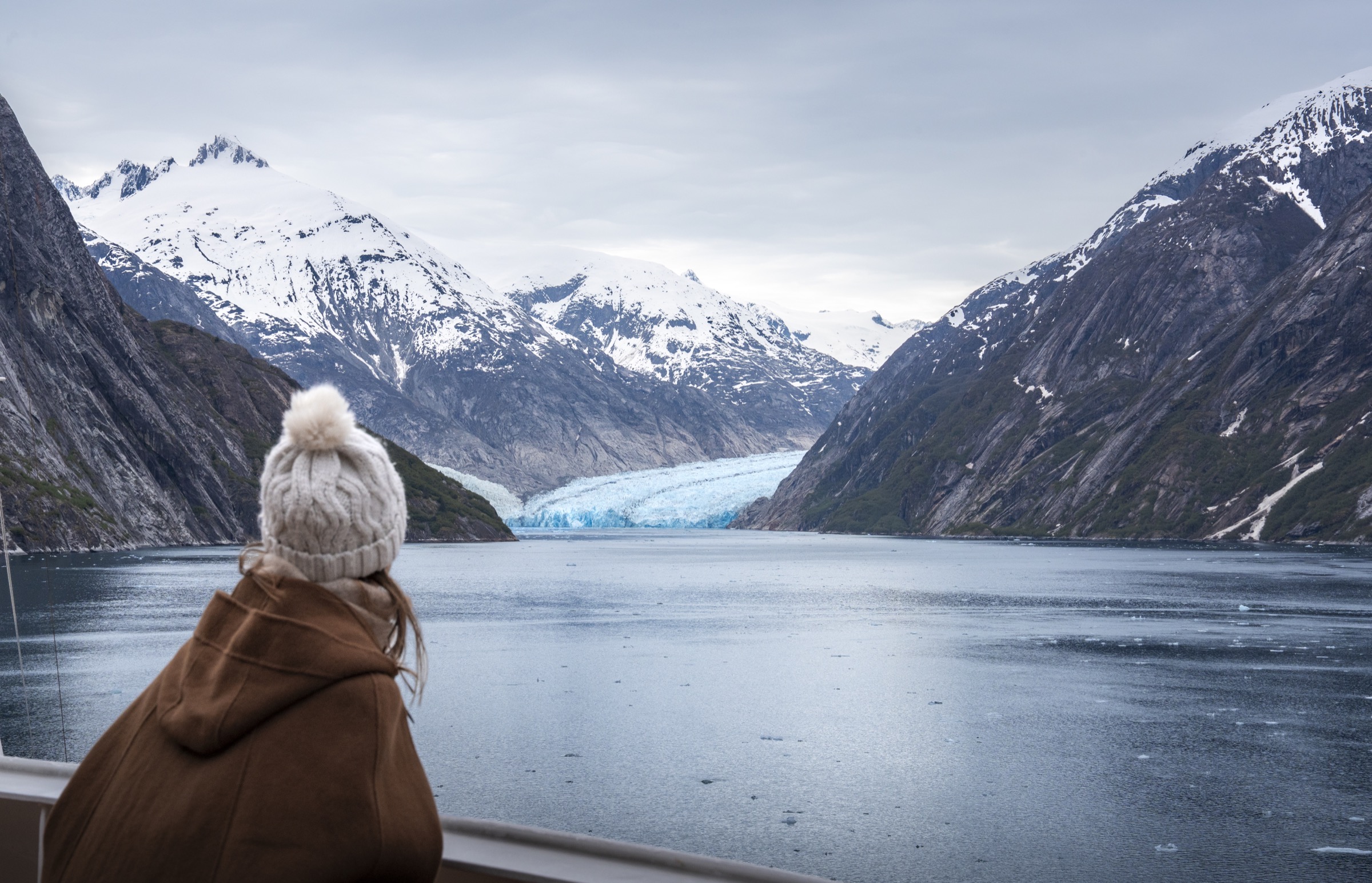 An Alaska glacier framed by snow-covered mountains